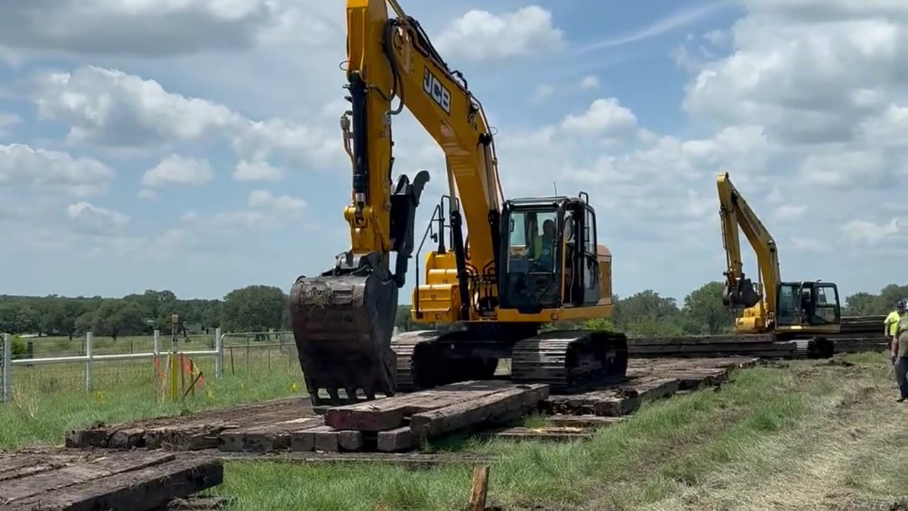 Excavators on a timber mat road